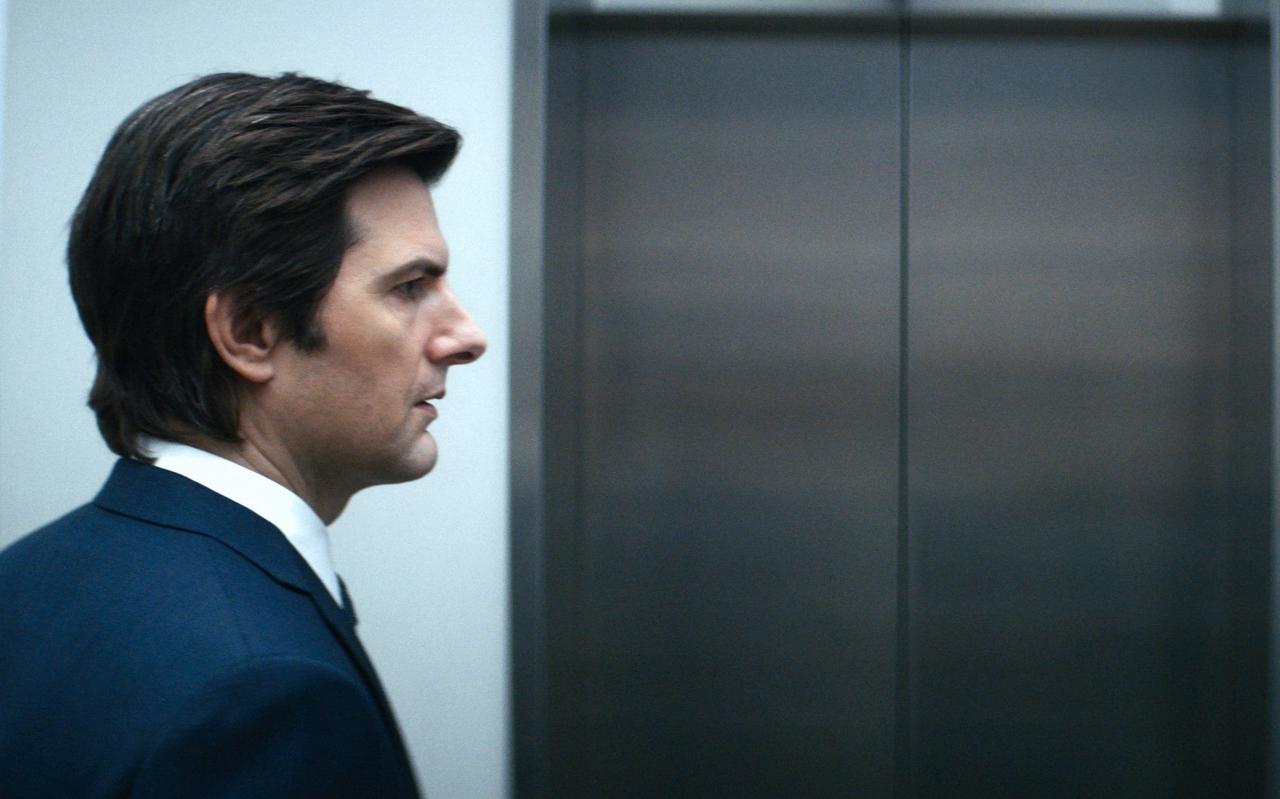 Image of Adam Scott wearing a suit in Severance