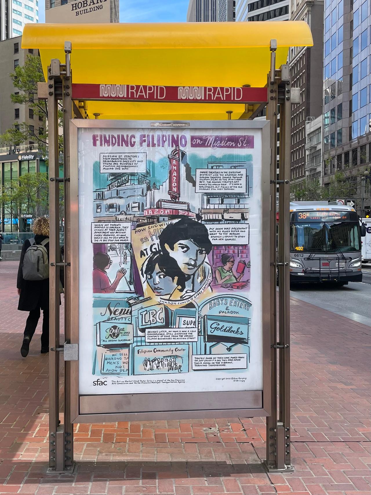 Photograph of a bus stop featuring a comic by Rina Ayuang