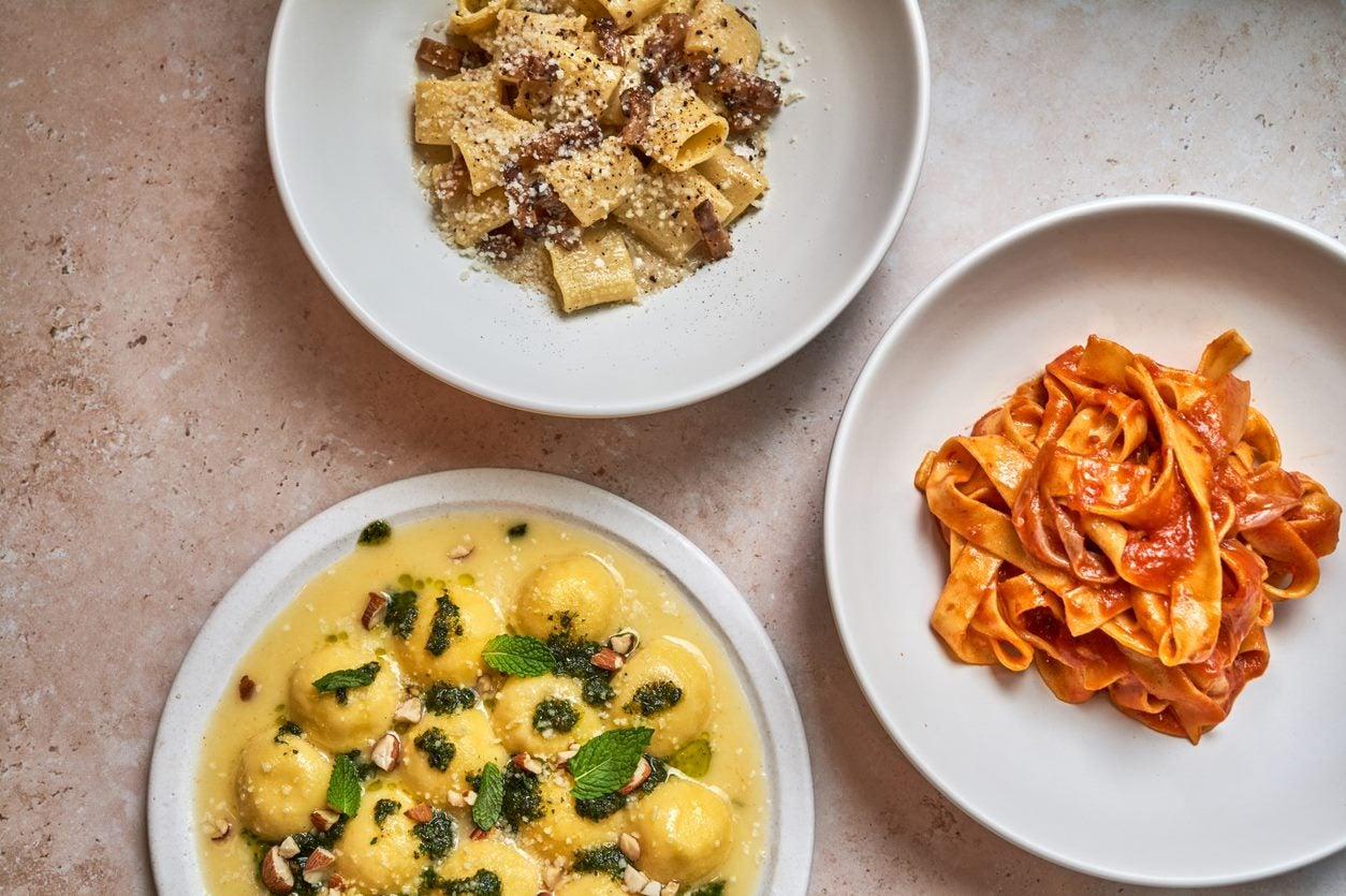 Photographs of three pasta dishes plated