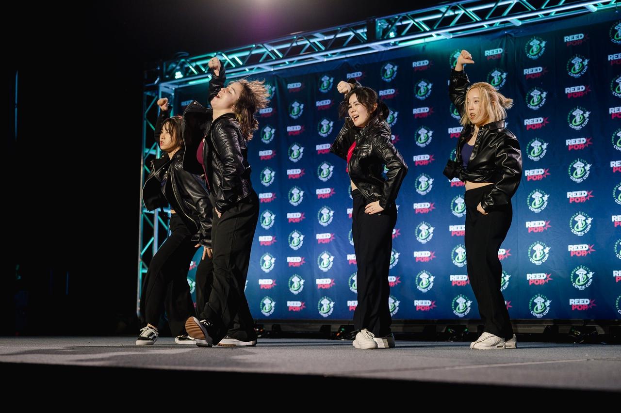 Photograph of fans dancing on stage