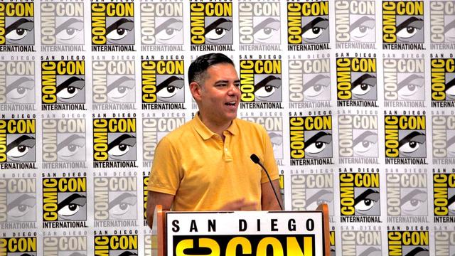 Photograph of Congressman Robert Garcia standing at a San Diego Comic Con podium