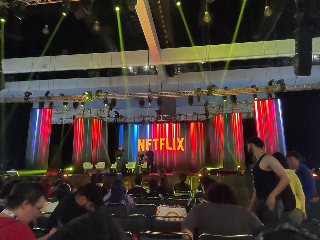 Photograph of a stage at Anime Expo with screens displaying the Netflix logo