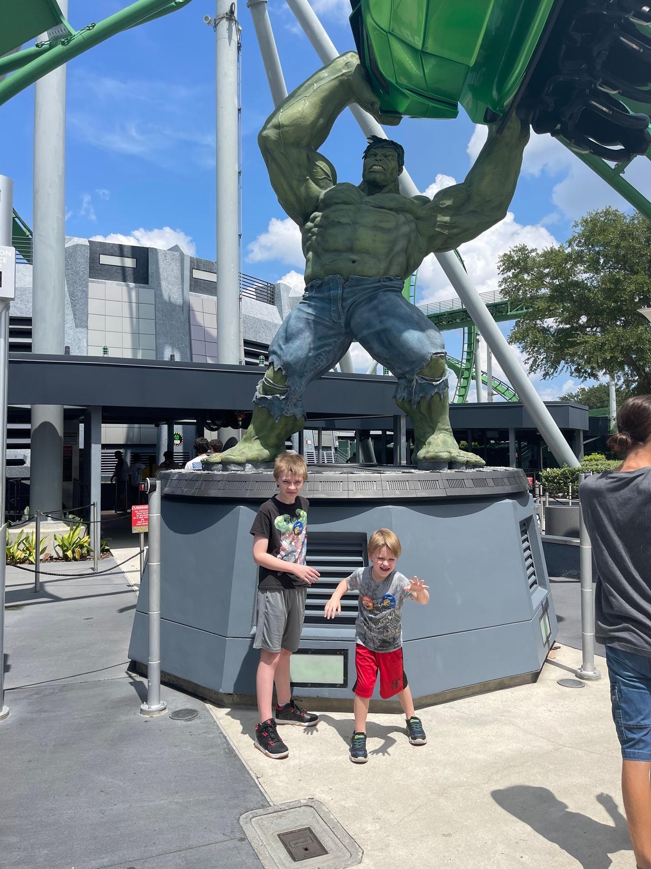 Two children pose in front of the new Hulk statue