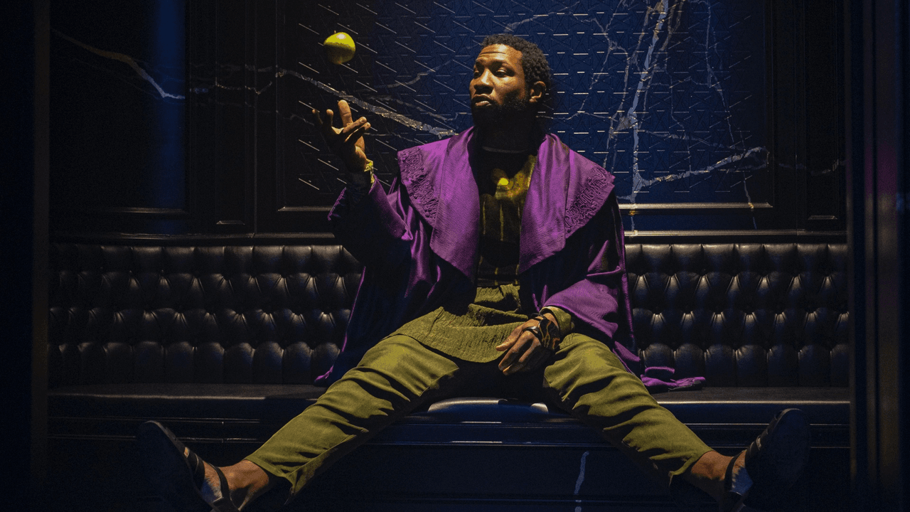 Jonathan Majors as He Who Remains tossing an apple into the air