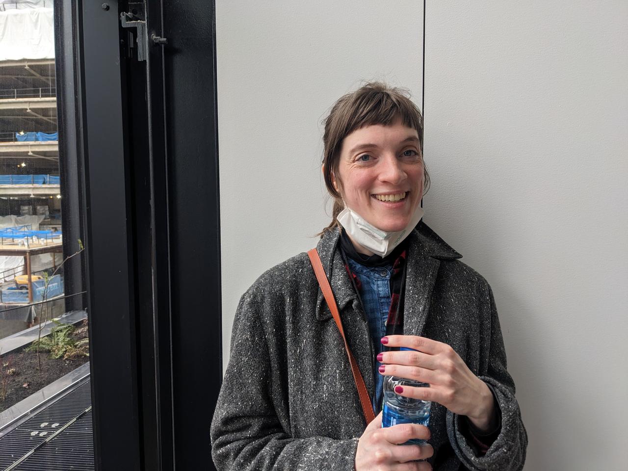 Photograph of Laura Knetzger by a window smiling