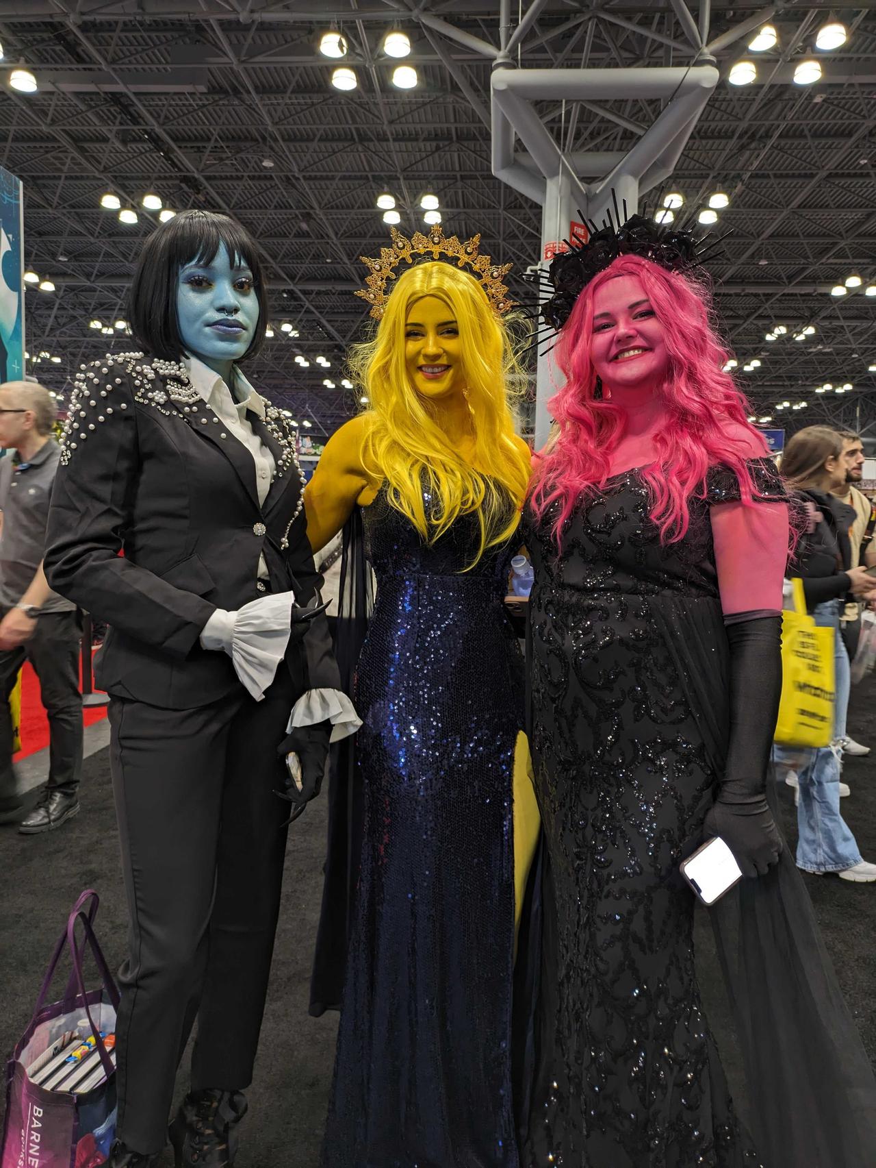 Photo of three Lore Olympus cosplayers