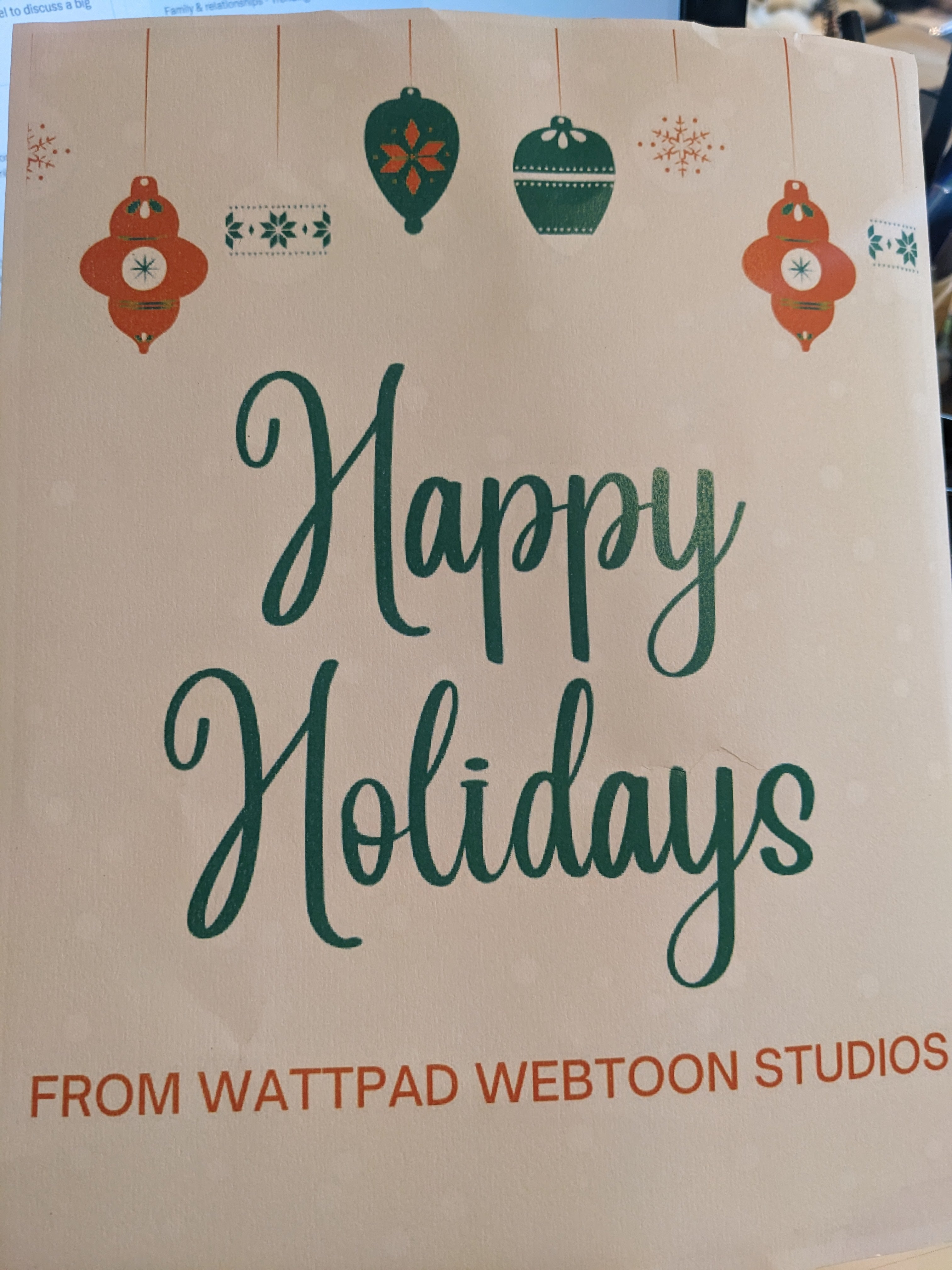 Photograph of a christmas card, that says happy holidays