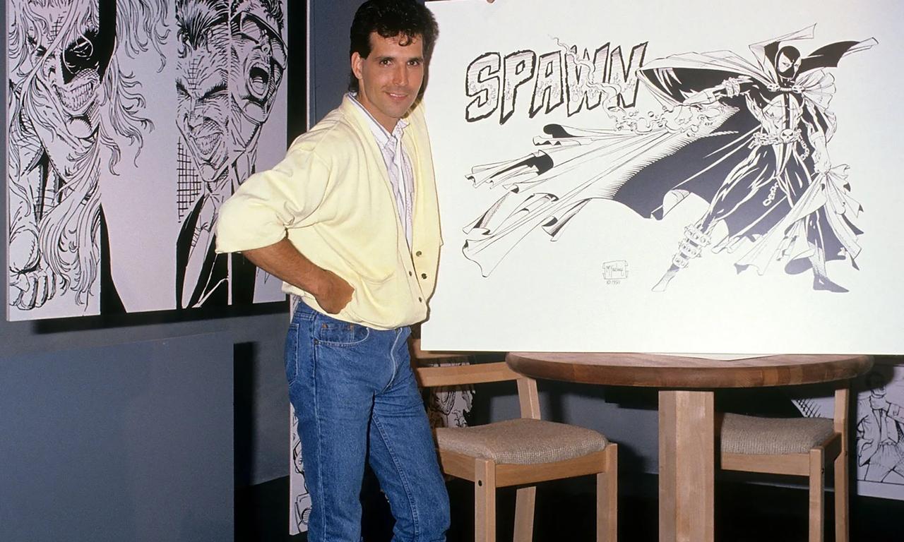 Todd McFarlane in front of a Spawn illustration